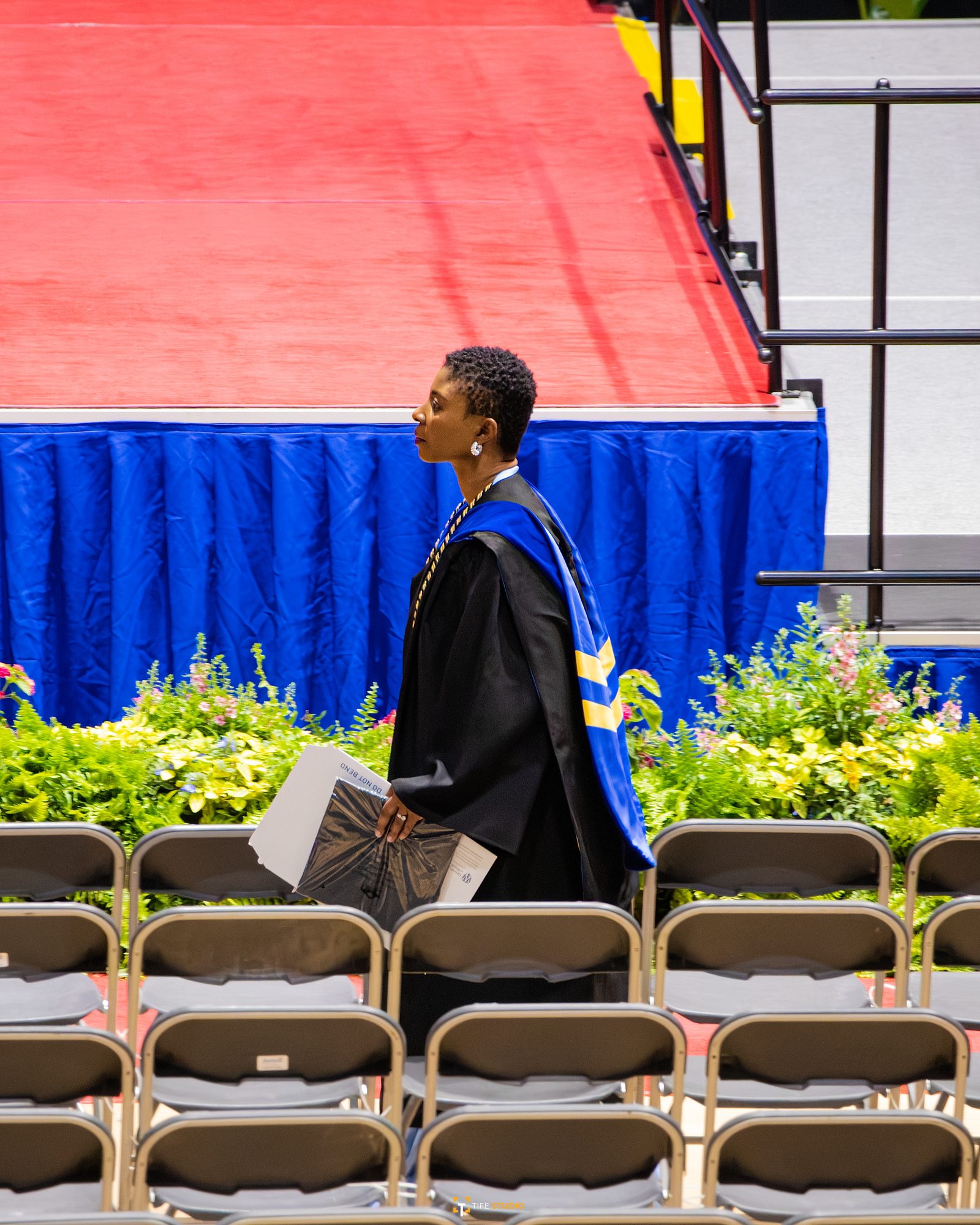 Graduate walking across ceremony stage